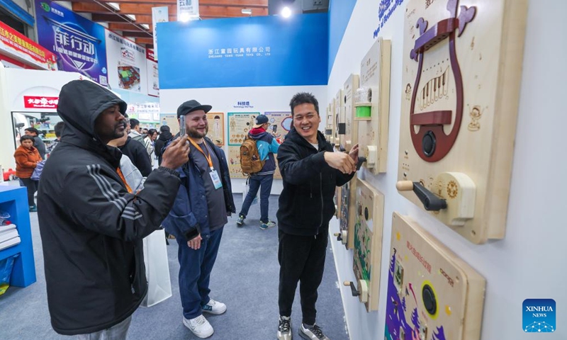 Traders visit an exhibition on wooden toy enterprises in Yunhe County, east China's Zhejiang Province, Nov. 11, 2023. (Photo: Xinhua)