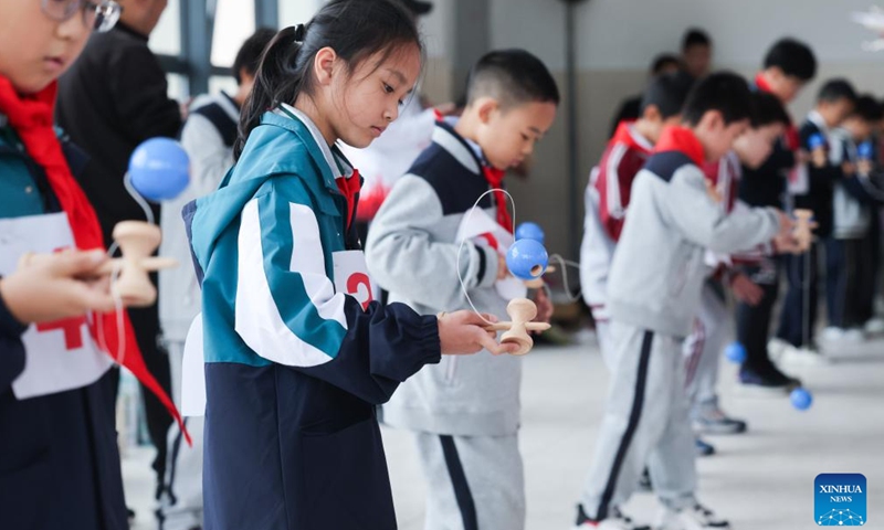 Children compete in a wooden toy playing competition during the 7th Yunhe Fairy-tale Wooden Toy Festival in Yunhe County, east China's Zhejiang Province, Nov. 11, 2023. (Photo: Xinhua)
