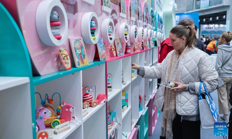 Foreign traders visit an exhibition on wooden toy enterprises in Yunhe County, east China's Zhejiang Province, Nov. 11, 2023. (Photo: Xinhua)