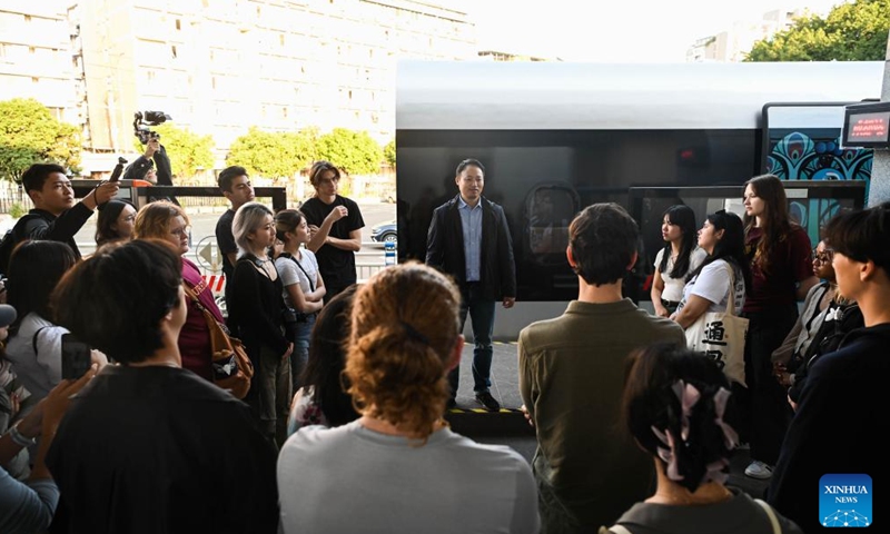 U.S. students participating in the China Education Tour learn about a prototype locomotive using high-temperature superconducting (HTS) maglev technology in Chengdu, southwest China's Sichuan Province, Nov. 6, 2023. More than 20 young people from the United States participated in the China Education Tour in southwest China's Sichuan Province recently. (Photo: Xinhua)