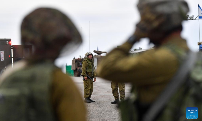 Israeli soldiers and members of Israeli rescue forces work near the scene where an anti-tank missile fired from Lebanon hit Moshav Dovev in north Israel Nov. 12, 2023. Hezbollah leader Sayyed Hassan Nasrallah said on Saturday that the Iran-backed armed group would continue to pressure Israel from southern Lebanon by conducting military operations. (Photo: Xinhua)