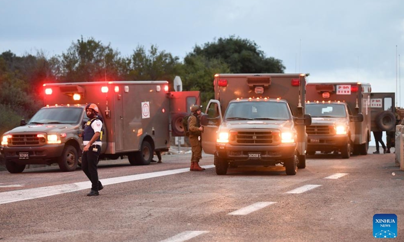 Israeli soldiers and members of Israeli rescue forces work near the scene where an anti-tank missile fired from Lebanon hit Moshav Dovev in north Israel Nov. 12, 2023. Hezbollah leader Sayyed Hassan Nasrallah said on Saturday that the Iran-backed armed group would continue to pressure Israel from southern Lebanon by conducting military operations. (Photo: Xinhua)