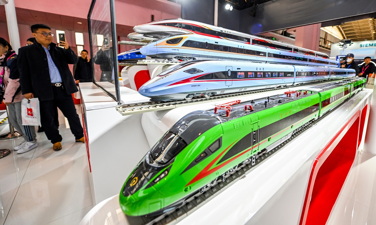A visitor takes photos of exhibits at the 16th China International Modern Railway Technology and Equipment Exhibition in Beijing on November 14, 2023. First established in 1992, it has become the most influential event in the Asian rail transportation industry, playing a significant role in promoting domestic and international railway technology exchanges. Photo: IC