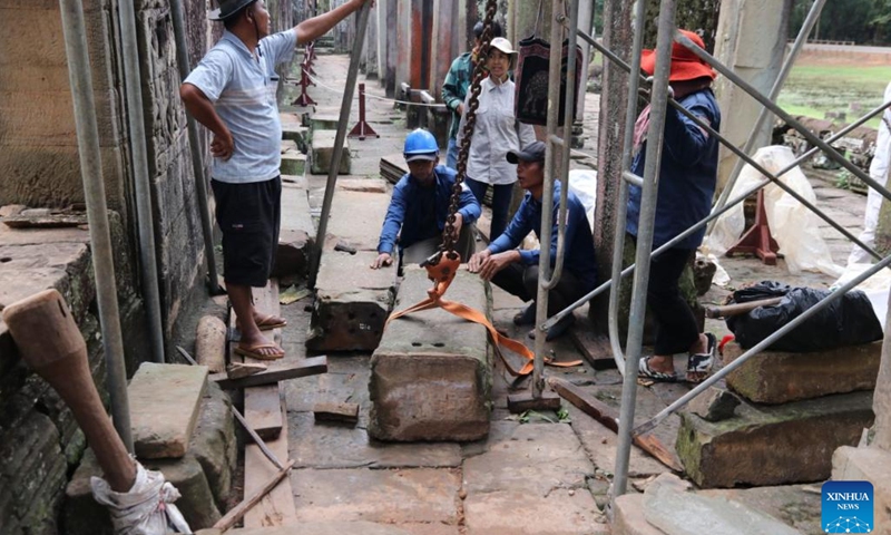 This undated photo shows staff members working at the restoration site of the west door frame of the Bayon temple in Angkor Archaeological Park in Siem Reap province, Cambodia. Restoration work has been underway at the west door frame of the Bayon temple in Cambodia's famed Angkor Archaeological Park, the Apsara National Authority (ANA) said in a news release on Monday.(Photo: Xinhua)