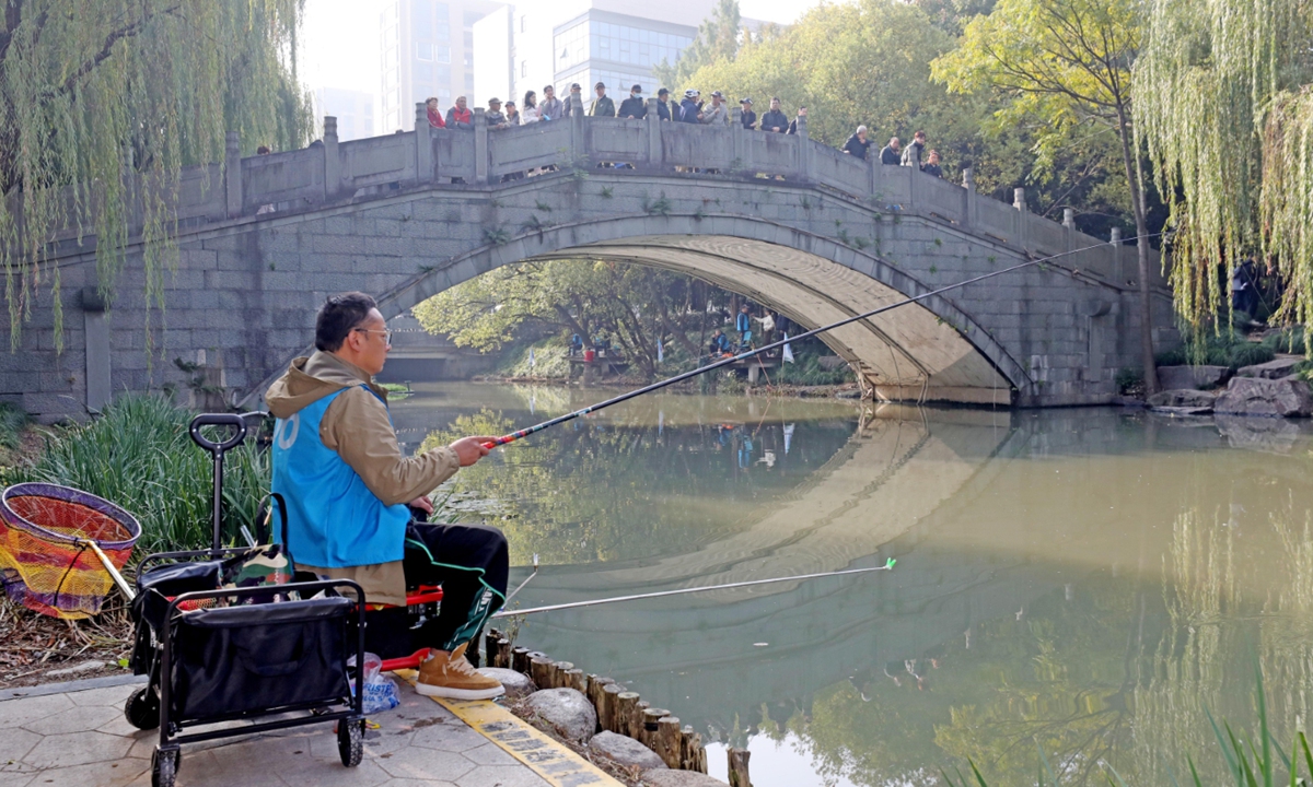 A man participates in a fishing competition in Hangzhou, East China's Zhejiang Province, on November 15, 2023. In recent years, the water quality of Hangzhou's urban rivers has continued to improve, and the rivers have become good places for nearby residents to entertain, relax and exercise. Photo: VCG