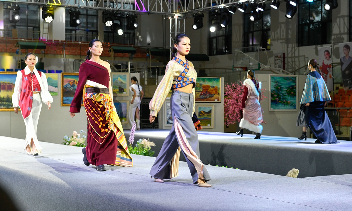 Models show clothing designed by graduates from a vocational college in Lhasa, Southwest China's Xizang Autonomous Region, at a graduation fashion show on May 26, 2023. The clothing showcases the encounter and collision between traditional Tibetan costumes and modern fashion design. Photo: VCG