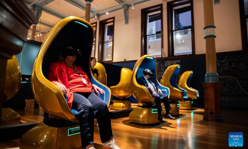 Journalists experience a VR project at the media preview of the Ramses and the Gold of the Pharaohs exhibition in Sydney, Australia, on Nov. 16, 2023. (Photo: Xinhua)