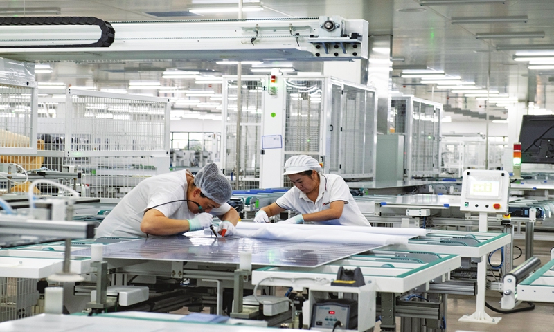 Workers are busy filling orders for solar photovoltaic modules on a production line in Jinhua, East China's Zhejiang Province on November 8, 2023. Photo: VCG