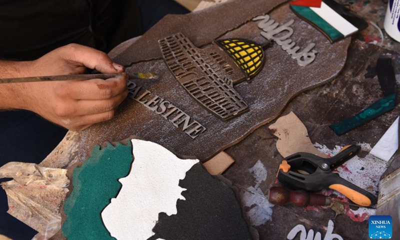 Hani al-Rakoui works on a piece of souvenir at his workshop in Damascus, Syria, Nov. 9, 2023. Hani al-Rakoui, a Palestinian refugee living in Syria, is on a unique journey to safeguard and promote the Palestinian heritage among the diaspora by creating artworks representing his homeland culture. (Photo: Xinhua)
