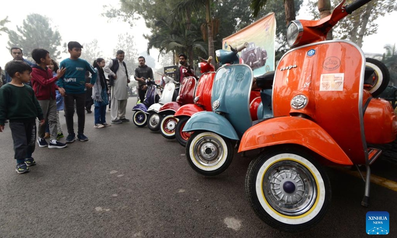 People look at motorbikes at a vintage and classic car show in Peshawar, Pakistan, Nov. 19, 2023. (Photo: Xinhua)
