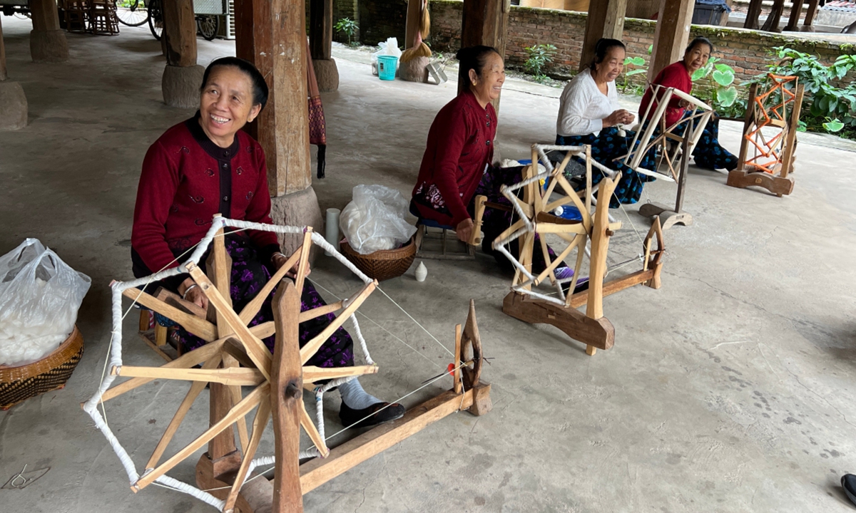 Dai ethnic women spin yarn with spinning wheels in Xishuangbanna, Southwest China's Yunnan Province. Photo: Lou Kang/GT