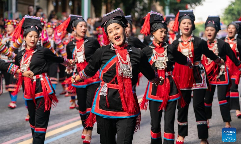 Local residents of Hani ethnic group attend a parade during a cultural tourism festival in Luchun County of Honghe Hani and Yi Autonomous Prefecture, southwest China's Yunnan Province, Nov. 19, 2023. The long street banquet, a time-honoured tradition of Hani ethnic group in China, was held here during a cultural tourism festival on Sunday. (Photo: Xinhua)