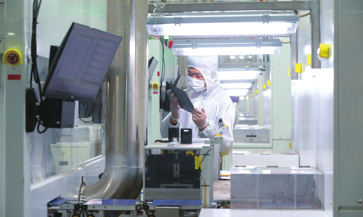 A worker processes solar cell wafers for export at a photovoltaic (PV) module manufacturing enterprise in Meishan city, Southwest China's Sichuan Province on November 20, 2023. The city has formed a PV industry chain of silicon wafers, batteries and modules. The products are exported to Germany, France and other countries and regions. Photo: VCG