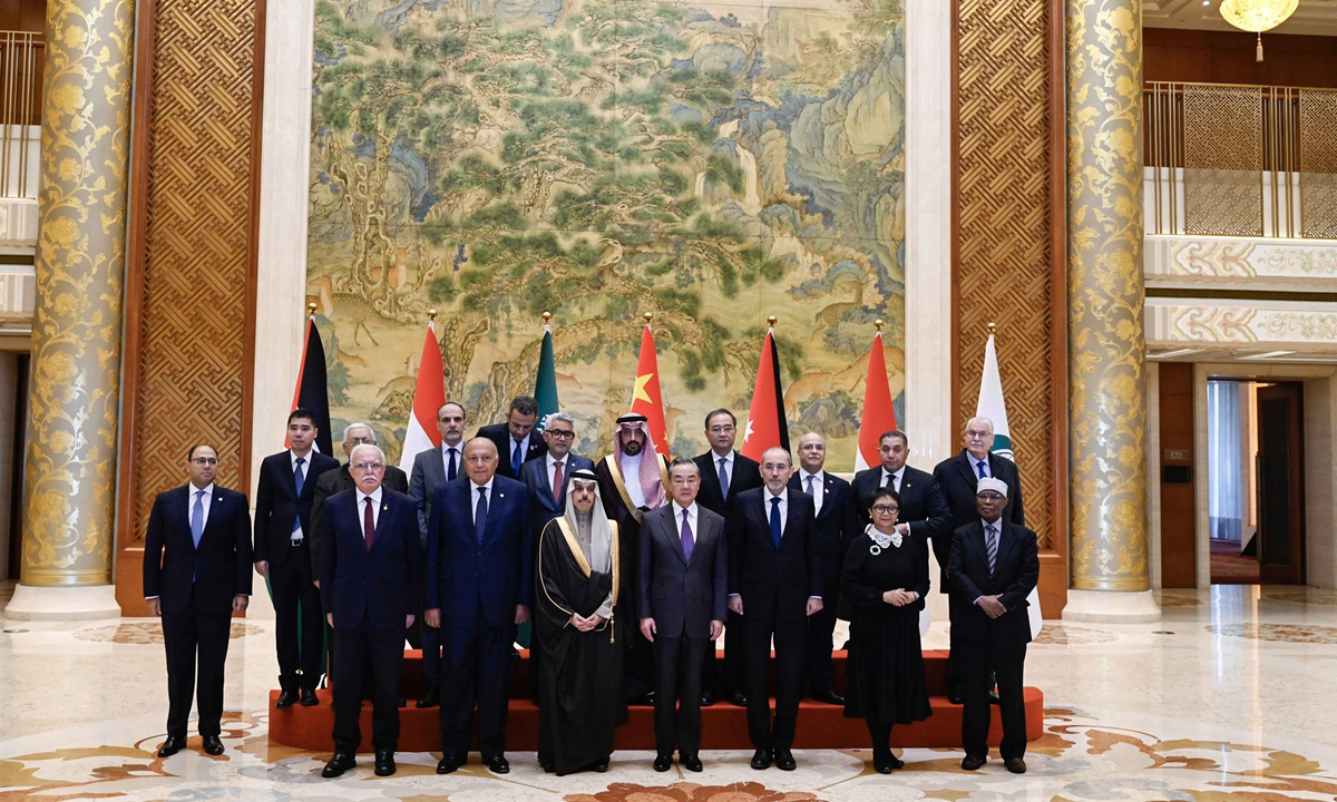Member of the Political Bureau of the Communist Party of China Central Committee and Foreign Minister Wang Yi and members of a delegation of foreign ministers from Arab and Islamic countries have a group photo in Beijing on November 20, 2023. Photo: AFP