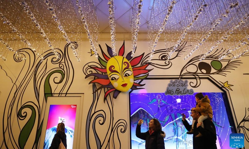 Pedestrians take photos of Christmas decorations at the Galeries Lafayette Haussmann department store, in Paris, France, Nov. 21, 2023. Department stores have unveiled their Christmas window displays for the upcoming festival.(Photo: Xinhua)