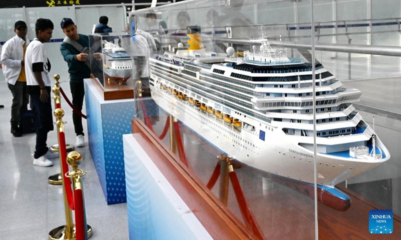 People visit the passenger transportation center of Qingdao Cruise Terminal in Qingdao, east China's Shandong Province, Nov. 21, 2023. Qingdao has been vigorously developing its cruise tourism service. As cruise voyages become increasingly frequent along with a climbing number of inbound tourists, they also contribute to the sustainable development of related sectors in the city. To date, Qingdao is connected by 40 international cruise lines to nearly 20 port cities.(Photo: Xinhua)