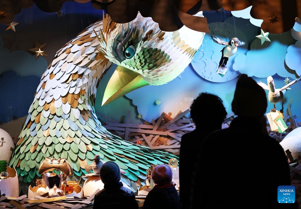 Pedestrians look at the Christmas window display at the Printemps Haussmann department store, in Paris, France, Nov. 21, 2023. Department stores have unveiled their Christmas window displays for the upcoming festival.(Photo: Xinhua)