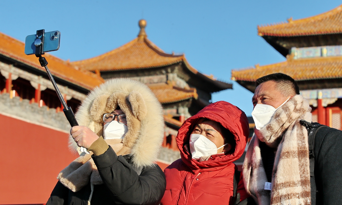 Tourists wearing thick winter clothes take selfies in the Forbidden City on November 24 in sub-zero temperatures in Beijing. The meteorological office of China's capital recently issued a cold wave warning, with a lowest temperature of -6 C on the day. Photo: IC