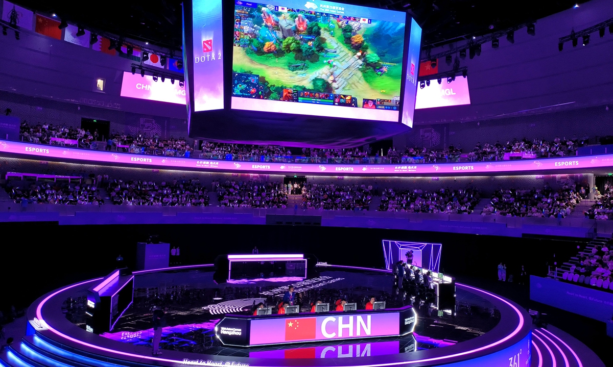 Chinese players compete in the Dota 2 final as the game is shown to spectators on a large screen at the Hangzhou Asian Games. Photo: VCG