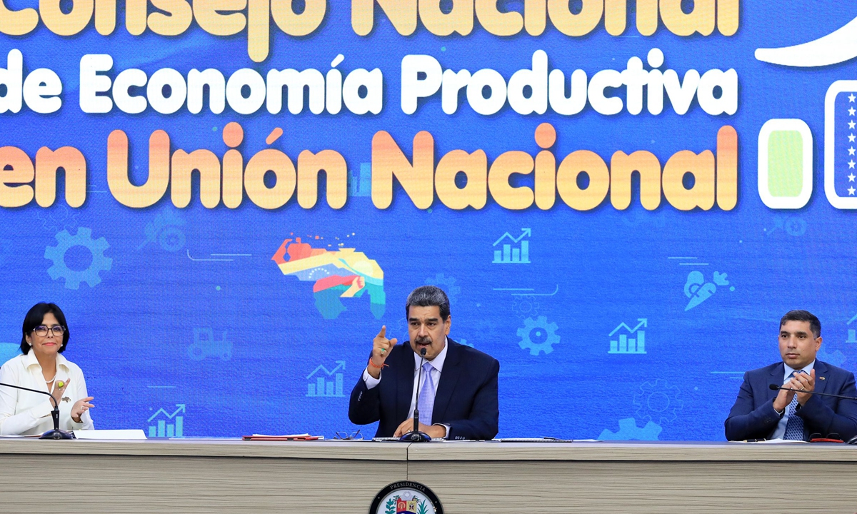Venezuelan President Nicolas Maduro (center) speaks next to Vice-President Delcy Rodriguez (left) and Oil Minister Pedro Tellechea during a meeting of the National Economic Council at Miraflores Presidential Palace in Caracas on November 28, 2023. Maduro reiterated his invitation to US President Joe Biden to begin a 