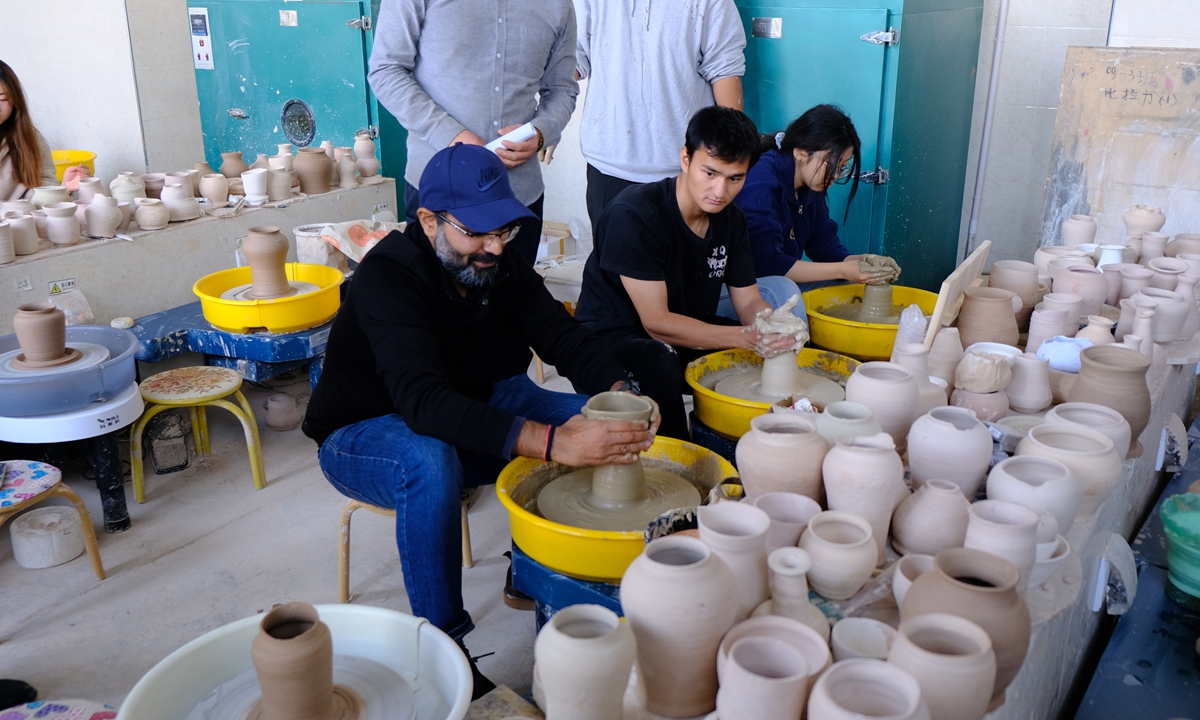 Shanghai Cooperation Organisation Deputy Secretary General Janesh Kane experiences pottery making in Kashi University, Xinjiang, on November 25, 2023. Photo: Leng Shumei/GT