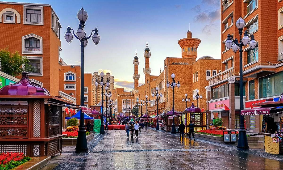 People walk on the street of the Xinjiang International Grand Bazaar in Urumqi. Photo: VCG