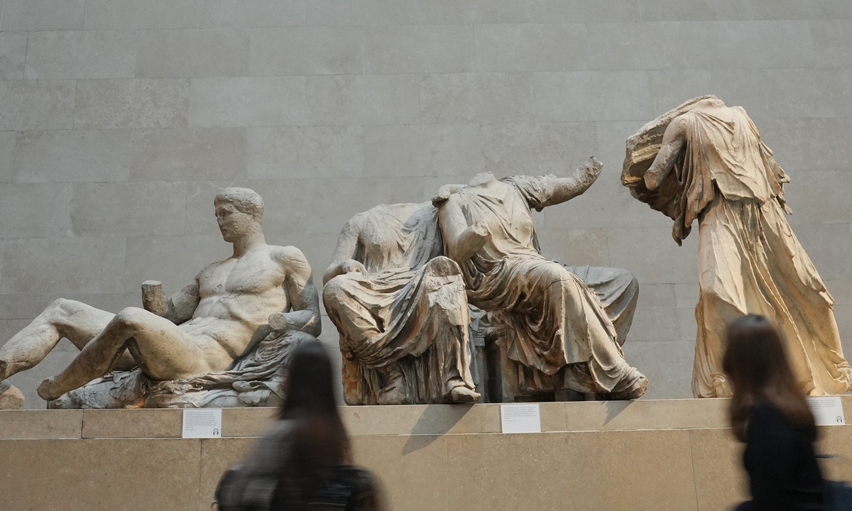 Visitors walk past sculptures that are part of the Parthenon Marbles at the British Museum in London, the UK. Photo: VCG