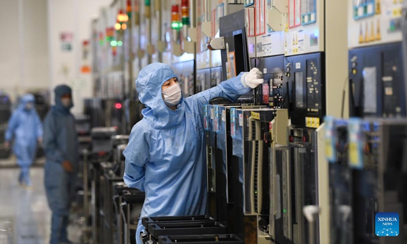 Workers work at a semiconductor wafer workshop of a company in the Western Science City in southwest China's Chongqing Municipality, Aug. 24, 2023. (Xinhua/Wang Quanchao)