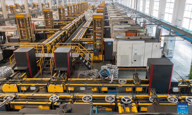 This aerial photo shows an automatic hub production line of a leading motorcycle wheel hub manufacturing enterprise in Dianjiang County of Chongqing, southwest China, Nov. 28, 2023. Chongqing is one of the important production and export bases of motorcycle parts in China. In recent years, Dianjiang County of Chongqing has guided local leading motorcycle wheel hub production enterprises to rely on scientific and technological innovations to promote industrial upgrading.(Photo: Xinhua)