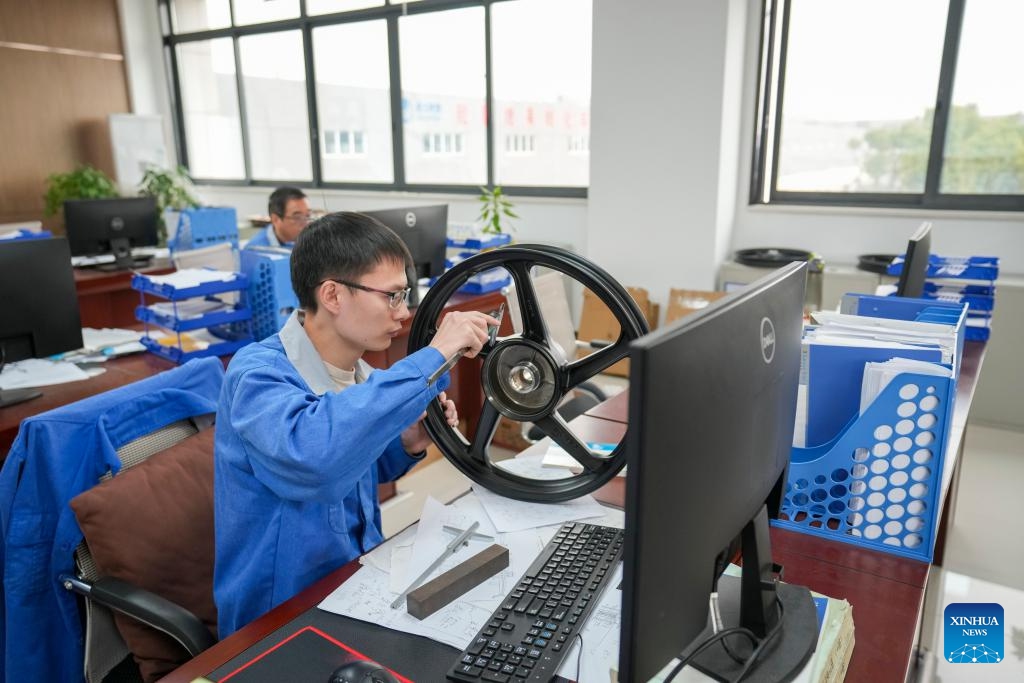 A man works on hub product improvement at a leading motorcycle wheel hub manufacturing enterprise in Dianjiang County of Chongqing, southwest China, Nov. 28, 2023. Chongqing is one of the important production and export bases of motorcycle parts in China. In recent years, Dianjiang County of Chongqing has guided local leading motorcycle wheel hub production enterprises to rely on scientific and technological innovations to promote industrial upgrading.(Photo: Xinhua)