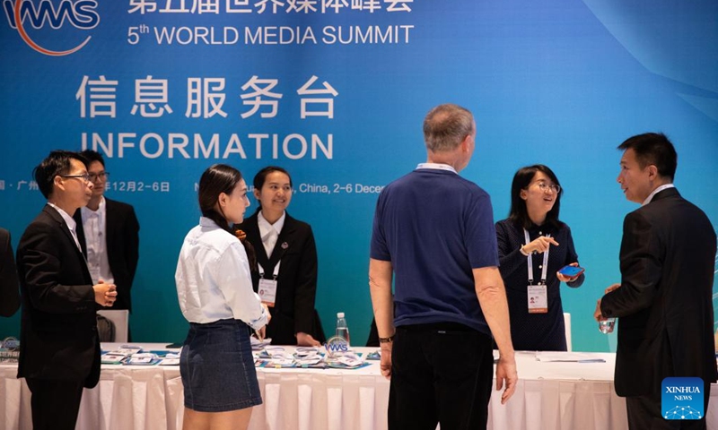 Staff members provide service for guests at the venue of the 5th World Media Summit in Nansha Bay Marina Convention Center in Guangzhou, south China's Guangdong Province, Dec. 2, 2023. (Photo: Xinhua)