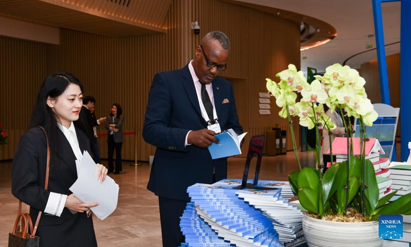A guest flips through publications at the venue of the 5th World Media Summit in Nansha Bay Marina Convention Center in Guangzhou, south China's Guangdong Province, Dec. 2, 2023. (Photo: Xinhua)