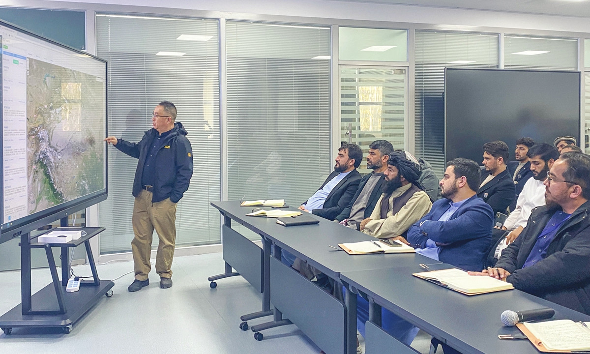 Wang Xiaowei (left), director of the Dunhuang grottoes monitoring center of the Dunhuang Academy, gives a speech to the Afghan delegation. Photo: Gao Ying/GT