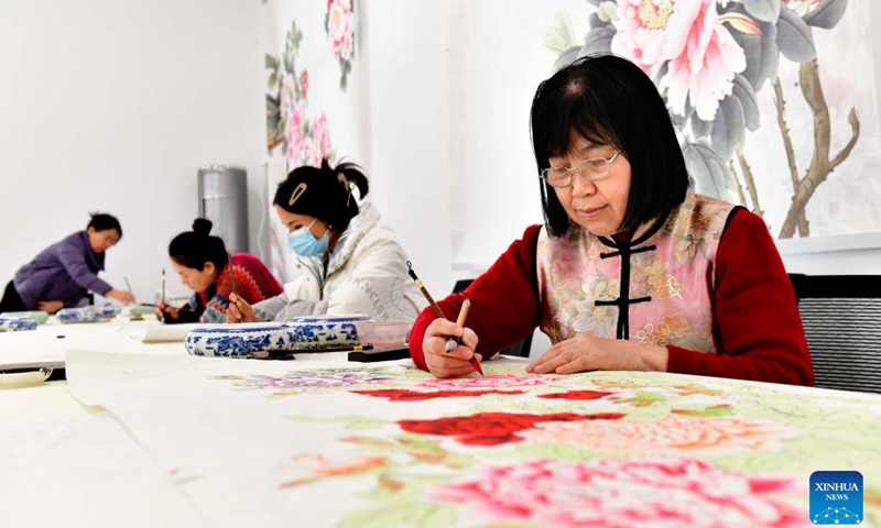 Farmers paint peony-themed realistic paintings at a studio in Juye County, Heze City of east China's Shandong Province, Dec. 2, 2023. Juye County is located in Heze, a city known for the cultivation of peonies. (Photo: Xinhua)