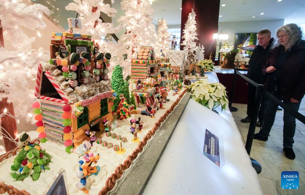 People look at gingerbread houses at a Gingerbread Lane event in Vancouver, British Columbia, Canada, on Dec. 5, 2023. Over 30 gingerbread houses are displayed during the annual event(Photo: Xinhua)