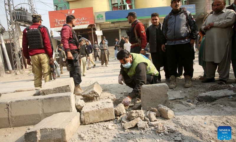 Security personnel examine the blast site in Peshawar, Pakistan, Dec. 5, 2023. Seven people including four children were injured in a blast outside a school in Pakistan's northwest Khyber Pakhtunkhwa province on Tuesday, rescue teams said.(Photo: Xinhua)