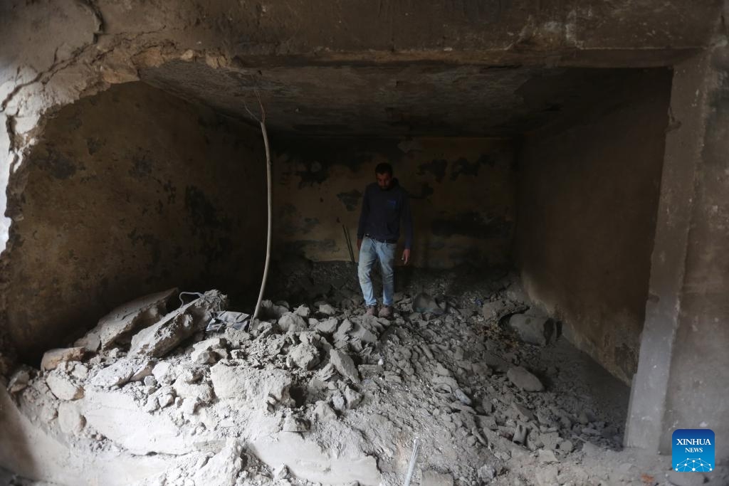 A man inspects a building destroyed during an Israeli raid in the West Bank city of Jenin, on Dec. 6, 2023.(Photo: Xinhua)