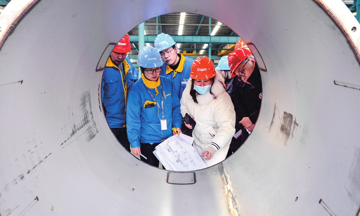 Workers check lithium battery manufacturing parts at a local factory in Wuxi city, East China's Jiangsu Province on January 14, 2022. Photo: VCG