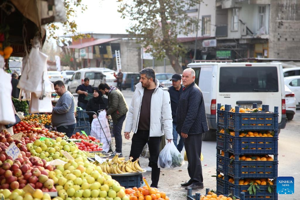 People shop at an open-air market in Kahramanmaras, Türkiye, Dec. 6, 2023. Kahramanmaras was the worst-hit province and the epicenter of the massive earthquakes in February this year. The reconstruction work has been carried out and residents here have got their lives back on track.(Photo: Xinhua)