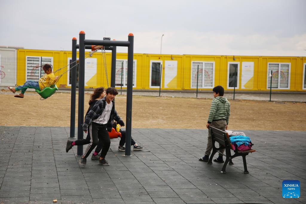 Children play at a community built with containers in Kahramanmaras, Türkiye, Dec. 6, 2023. Many communities have been built with containers in Kahramanmaras after the massive earthquakes in February this year. They are equipped with schools, banks, supermarkets, laundries, drug stores, etc. The largest community can provide accommodation for around 7,000 locals.(Photo: Xinhua)