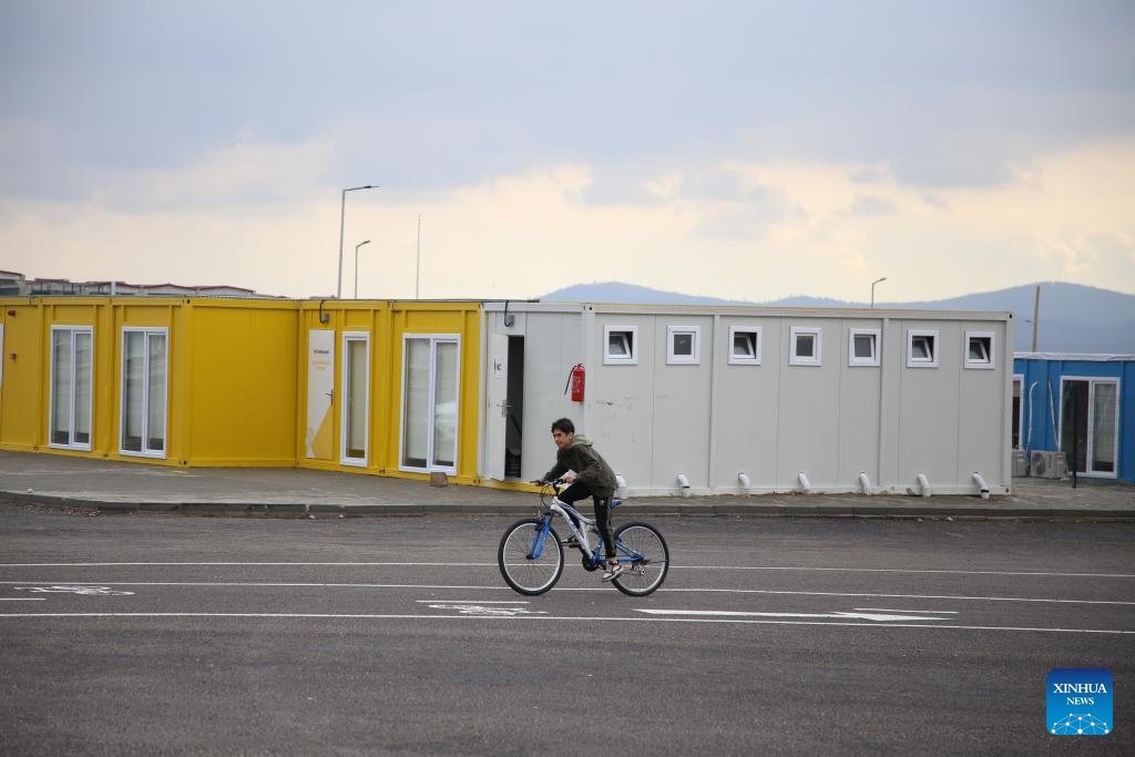 A boy rides a bike at a community built with containers in Kahramanmaras, Türkiye, Dec. 6, 2023. Many communities have been built with containers in Kahramanmaras after the massive earthquakes in February this year. They are equipped with schools, banks, supermarkets, laundries, drug stores, etc. The largest community can provide accommodation for around 7,000 locals(Photo: Xinhua)