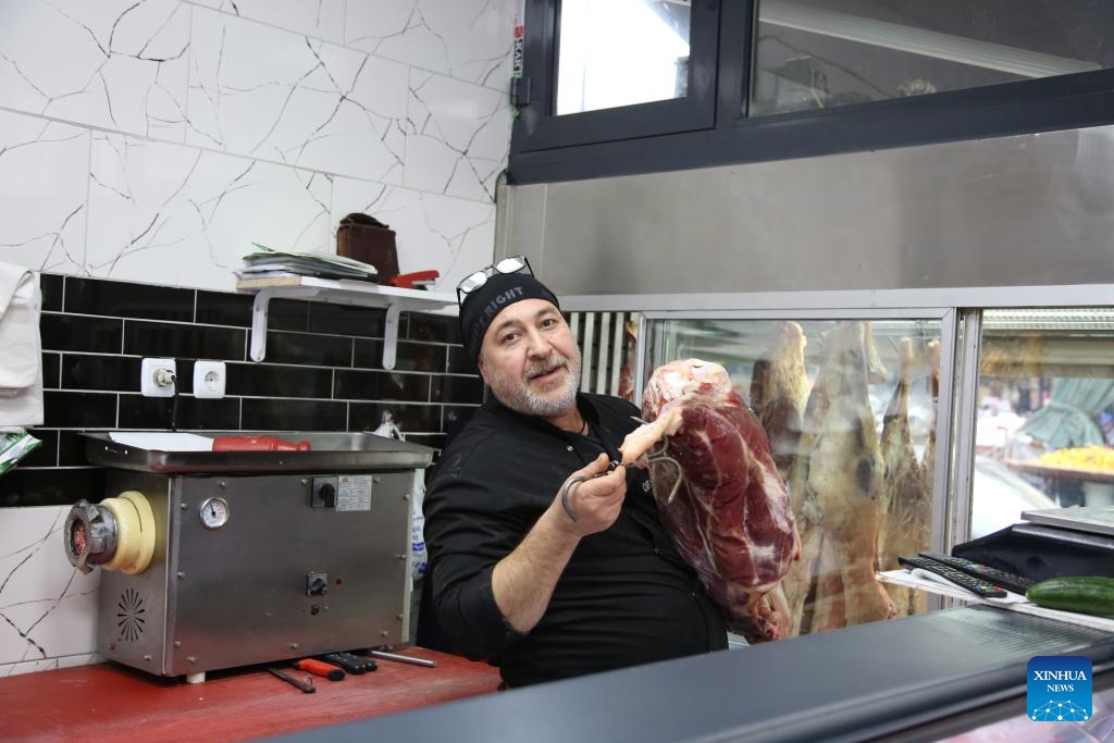 A man works at a butcher's shop in Kahramanmaras, Türkiye, Dec. 6, 2023. Kahramanmaras was the worst-hit province and the epicenter of the massive earthquakes in February this year. The reconstruction work has been carried out and residents here have got their lives back on track.(Photo: Xinhua)