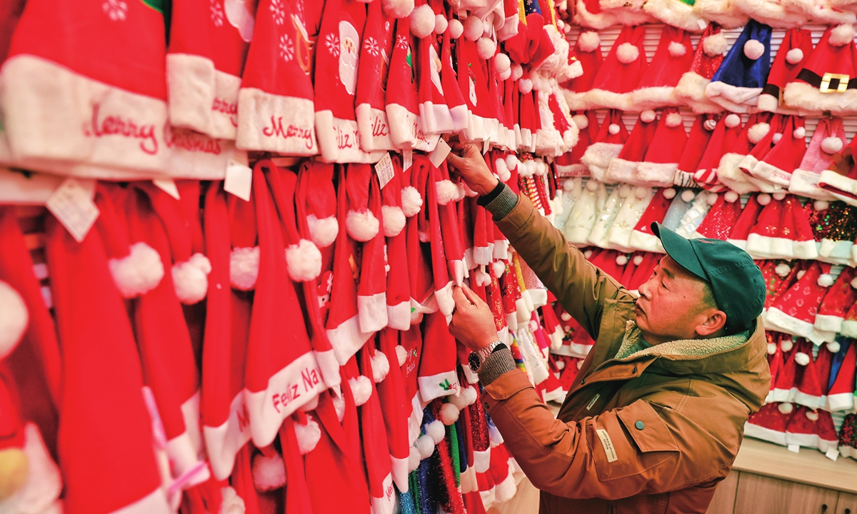 A vendor organizes Christmas products in Yiwu International Trade Market in East China's Zhejiang Province on December 4, 2023. Photo: Li Hao/GT