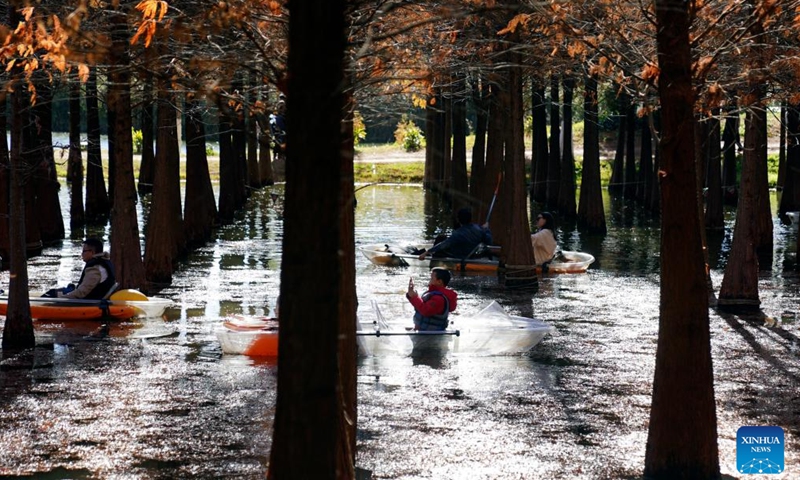 Tourists row boats at Haihong Wetland Park in Kunming, southwest China's Yunnan Province, Dec. 9, 2023. (Photo: Xinhua)