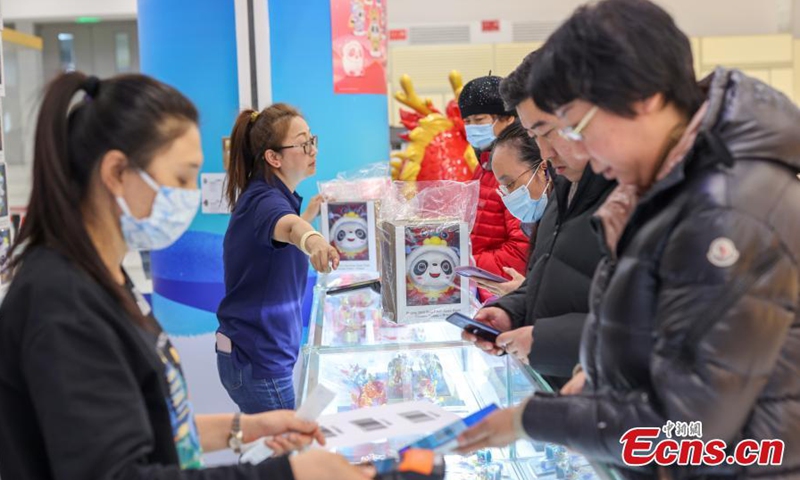 Customers select Chinese zodiac Dragon version of Bing Dwen Dwen, a Beijing Winter Olympic Games mascot, at a store in Beijing, Dec. 7, 2023. (Photo: China News Service)