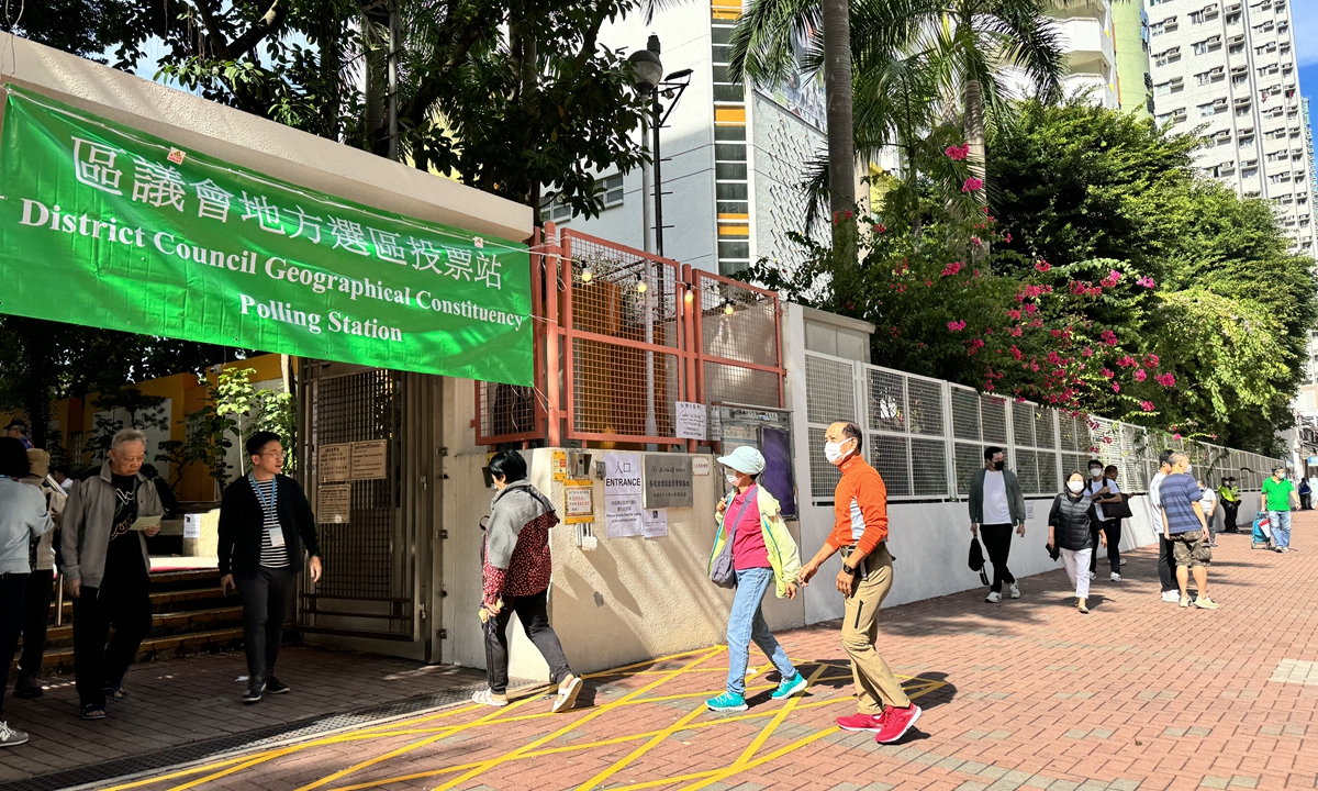 Local residents walk into a polling station in Yaumati Catholic Primary School in Hong Kong on Sunday morning to cast their votes for 7th District Council Election. (Photo: Chen Qingqing/GT)