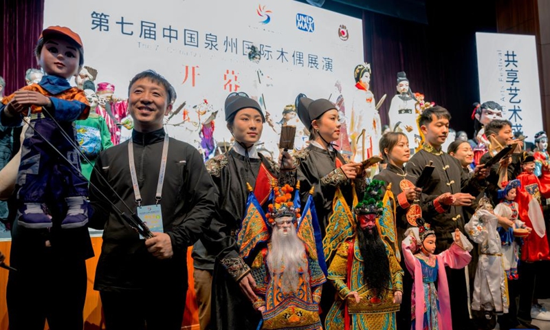 Puppet artists present their puppets to the audience before the opening of the 7th China Quanzhou International Puppet Festival in Quanzhou, southeast China's Fujian Province, Dec. 9, 2023. The puppet festival opened here on Saturday as part of the fifth Maritime Silk Road International Arts Festival. Artists from 35 puppet show teams will put on more than 80 performances over the next four days. (Photo: Xinhua)