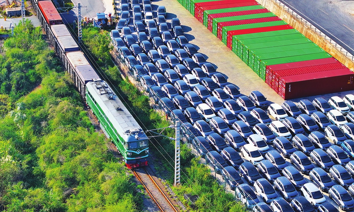 A freight train departs from Ganzhou International Inland Port, East China's Jiangxi Province on December 6, 2023, as a staging area of NEVs await shipment abroad. Photo:VCG