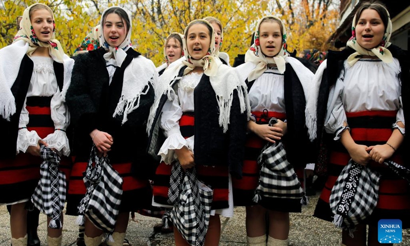 Members of a traditional song and dance band sing during the White Flowers festival of traditions and customs at the Village Museum in Bucharest, capital of Romania, on Dec. 10, 2023. The festival is organized annually with the aim of presenting Christmas and New Year traditions to the public. (Photo: Xinhua)
