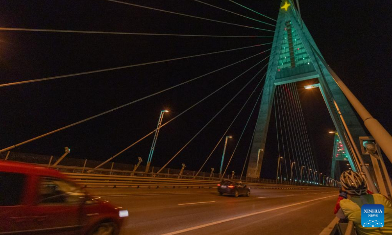 Christmas lights are pictured at the Megyeri Bridge over the Danube river in northern Budapest, Hungary on Dec. 17, 2023. (Photo by Attila Volgyi/Xinhua)